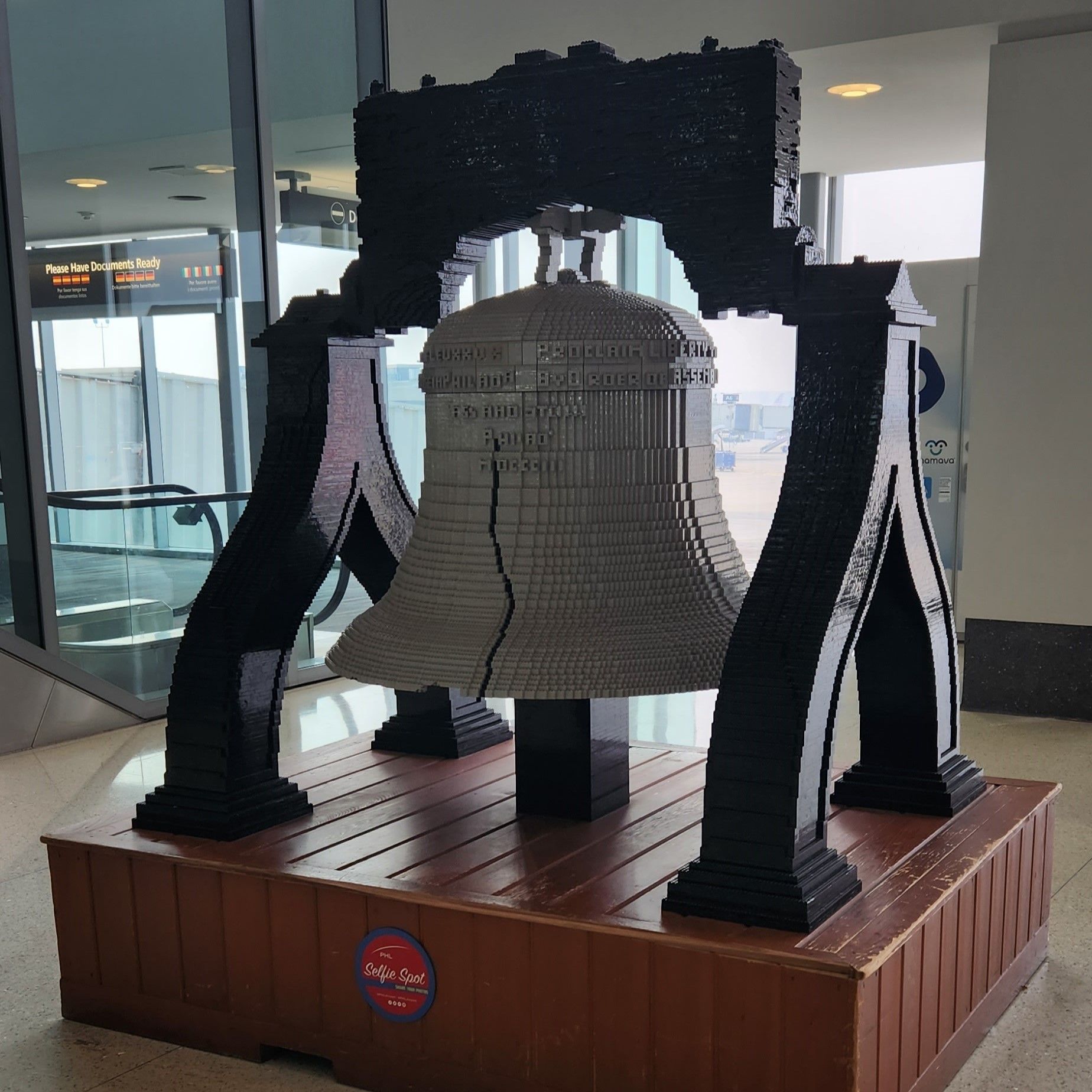 A large bell made out of Lego bricks.